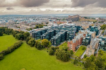 Edinburgh aerial top view. The neo-gothic structures of Edinburgh’s historic castle form silhouettes against the sky, providing a romantic view that has attracted visitors for years