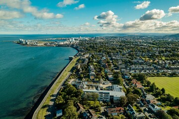 Fototapeta premium Aerial View of Edinburgh, harbour. Iconic marina, the sun sets over the city of Edinburgh, the breath-taking architecture of this capital city making it a popular tourist destination