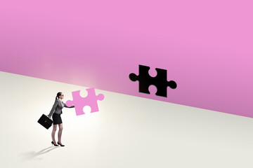 Obraz na płótnie Canvas Businesswoman putting missing jigsaw puzzle piece