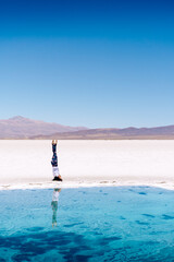 person doing headstand in the desert