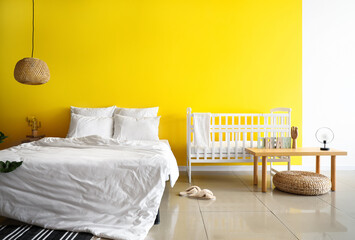 Interior of bright bedroom with white crib