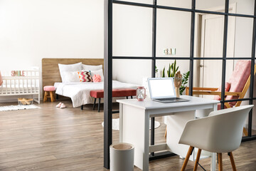 Modern workplace and folding screen in stylish bedroom