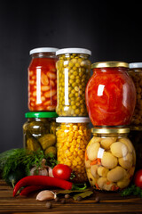 Jars with variety of pickled vegetables.