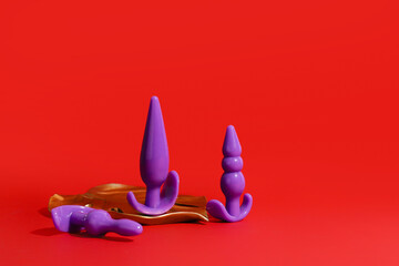 Rubber butt plugs on color background