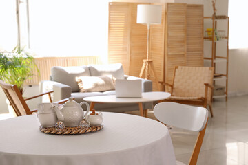 Tea set on dining table in studio apartment