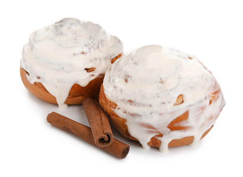 Tasty cinnamon rolls with cream on white background
