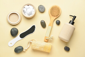 Bath supplies for foot massage with spa stones on color background