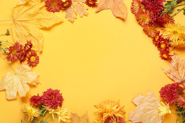 Naklejka na ściany i meble Frame made of chrysanthemum flowers and autumn leaves on color background, closeup