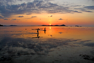 Two fishermen on their way home after work at sunset in Palawan, Philippines.