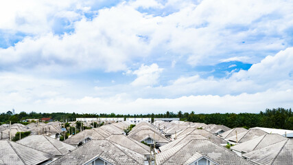 Arial view cloudy clouds sky with white gray roof tiles home.clean roof. Cleaning roof tiles...