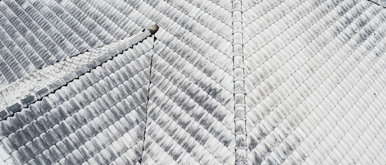 Close up top view of white gray roof tiles.Old dirty and clean roof. Modern roof tiles houseware....