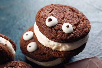 Funny chocolate cookies on dark background, closeup