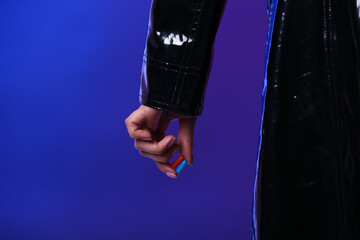 Woman with blue and red pills on color background. Concept of choice