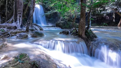 Tuinposter Erawan waterfalls in the national park mountains of Kanchanaburi BKK Bangkok Thailand lovely turquoise blue creamy waters lush green trees smooth rock formations © Elias Bitar