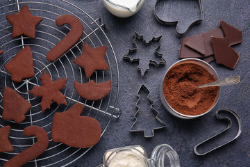 Grid with tasty chocolate Christmas cookies on black background, closeup
