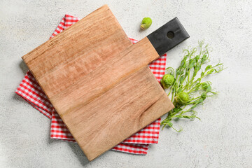 Wooden cutting board with Brussel sprouts, micro green and napkin on white background