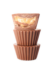 Tasty peanut butter cups on white background