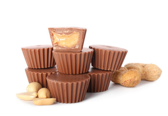 Tasty peanut butter cups on white background