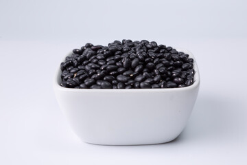 black bean in white bowl on white background studio shot