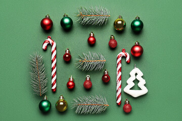 Composition with fir branches and beautiful Christmas decorations on green background