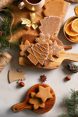 Wooden boards with sweet Christmas gingerbread cookies on light background
