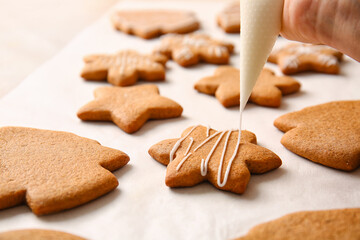 Preparing of sweet Christmas gingerbread cookies on light background