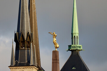 Spire and bell towers of gothic Notre-Dame Cathedral Luxembourg and Golden Lady or Gelle Fra Monument of Remembrance - obrazy, fototapety, plakaty