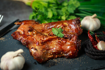 Homemade roast rat, Steak knife, fork, dipping sauce, steak knife, potato wedges close up on a slate board with dark gray color paint, old crumpled paper. Horizontal top view from above,grilled rats.