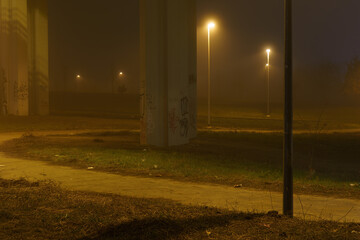 street lights under a concrete bridge in the fog in the city of Prague at night 2021