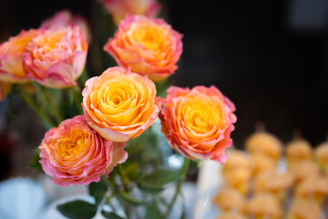 Beautiful bouquet of yellow - orange rose. Fresh roses in a vase decorated on the table close up.
