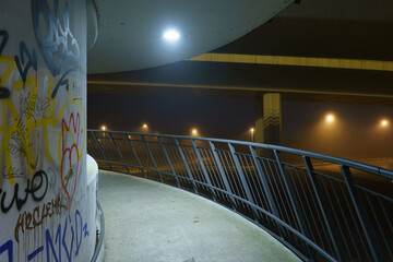 street lights under a concrete bridge in the fog in the city of Prague at night 2021