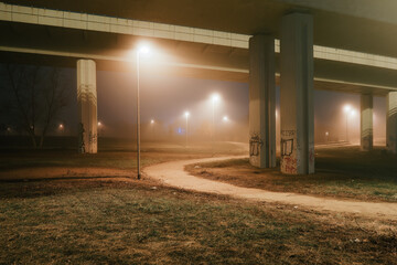 street lights under a concrete bridge in the fog in the city of Prague at night 2021