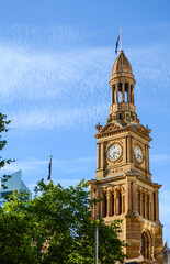 Historical clock tower at sydney Town hall, Australia with blue sky background.
