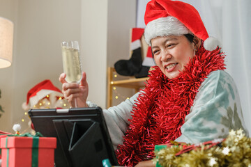 asian woman toasting champagne celebrate new year and Christmas party video call friends at home