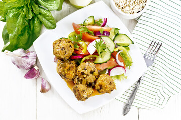 Meatballs with spinach and oatmeal on board top