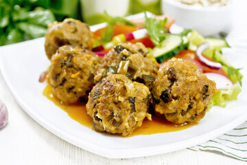 Meatballs with spinach and oatmeal on board