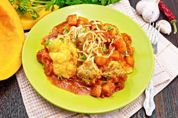 Porridge corn with meat and vegetables in plate on board