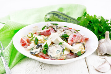 Salad with fried zucchini in plate on board