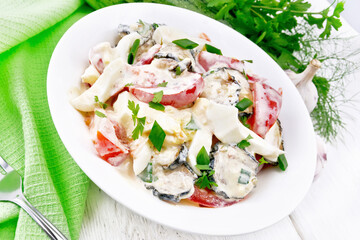 Salad with fried zucchini in plate on white board