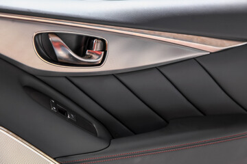 Close up shot of luxurious car interior door trim.