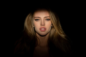 Fototapeta premium Beauty portrait of beautiful female model, fashion glamour portrait. Beauty female face. Beautiful female face in the darkness.