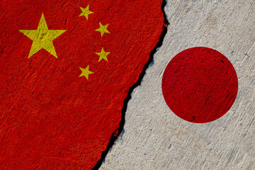 chinese and japan flags painted on cracked concrete wall, china and japan conflict or partnership concept