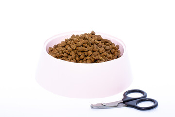 scissors for animal nail isolated and pink bowl on a white background.