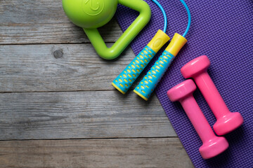 Time for exercising sport equipment with yoga mat background and wooden table
