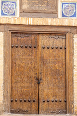 Door of the Allakuli Khan Madrassah. Ichan Kala (or Itchan Qala is walled inner town of the city of Khiva, a UNESCO World Heritage Site), Khiva city, Uzbekistan.