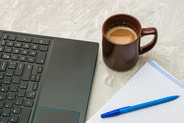 coffee mug laptop and notebook with a fountain pen on the table
