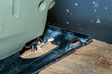 jigsaw is cutting timber with wood chips