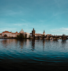 Fototapeta premium Panoramic view of Charles Bridge on the Vltava river in the center of Prague on a sunny day 2021 during storm