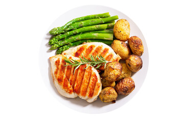 plate of grilled chicken, asparagus and baked potatoes isolated on white background