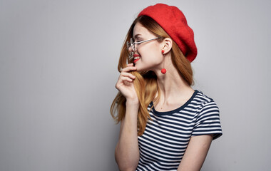 Fototapeta premium pretty woman in a striped t-shirt red lips gesture with his hands